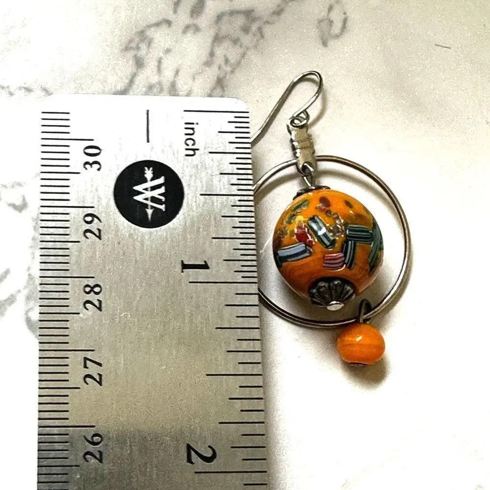 Silver tone orange beaded drop earrings